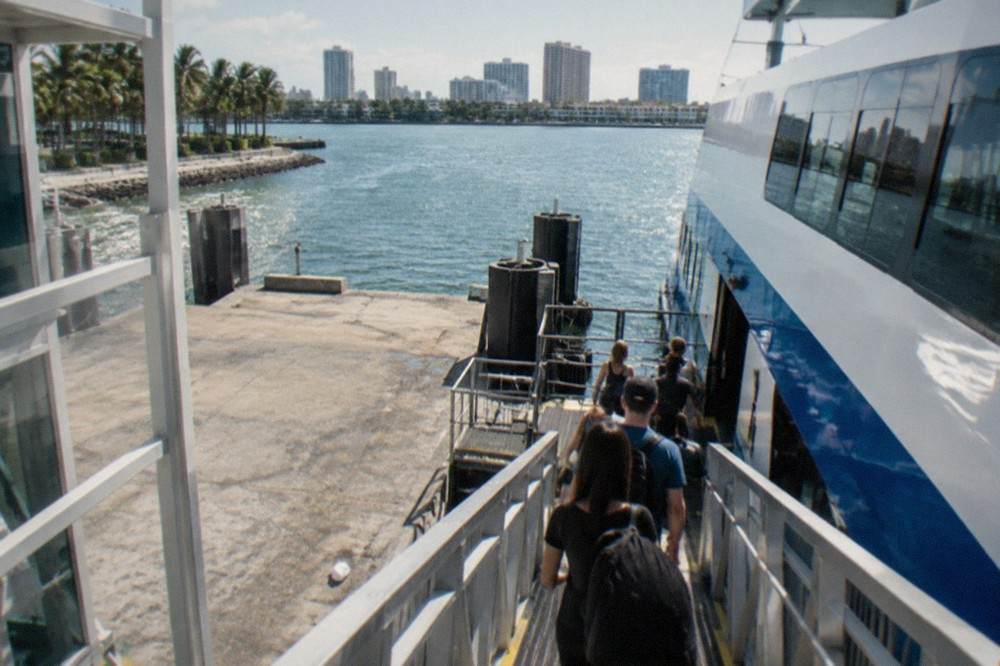 Ferry terminal boarding ramp with passengers waiting to board
