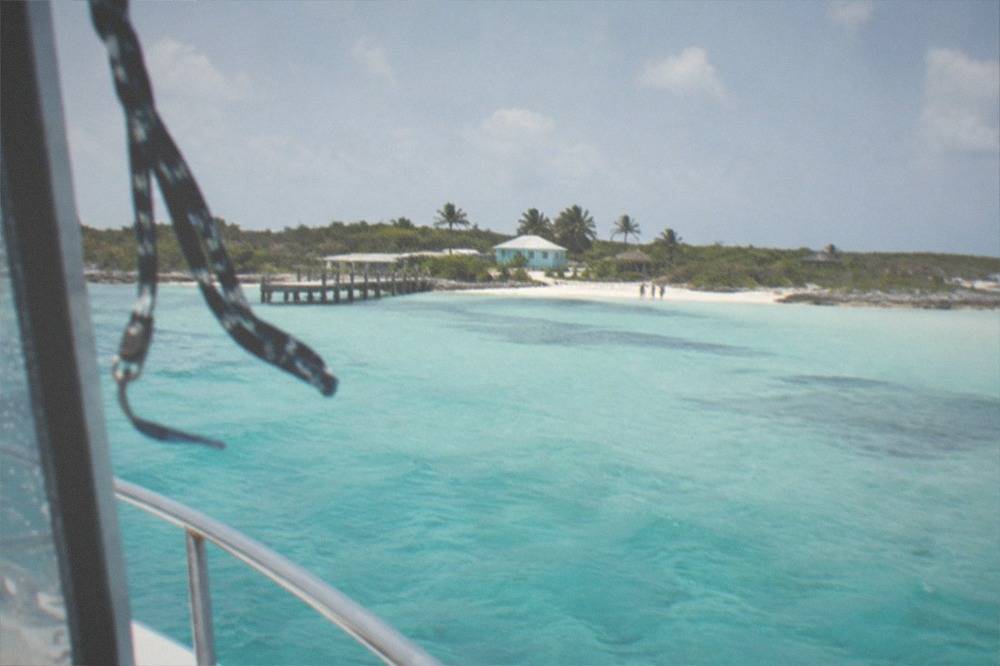 Turquoise water and sandy beach seen from a ferry approaching an island