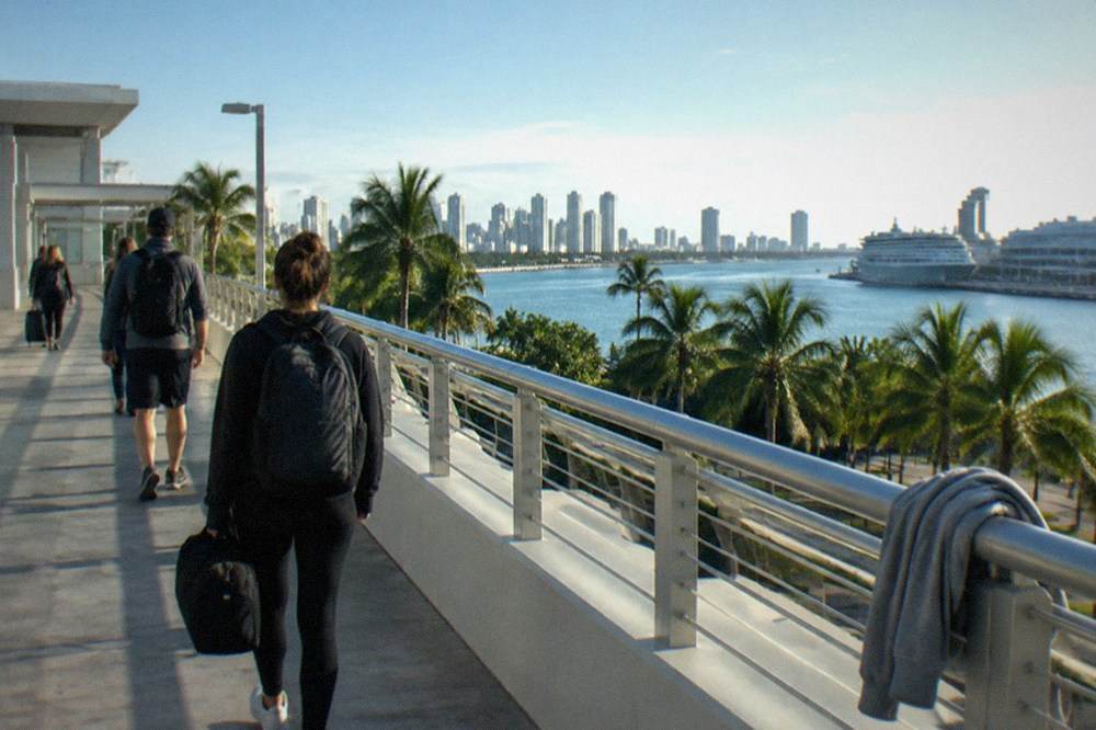 Ferry terminal walkway at morning with passengers carrying small bags