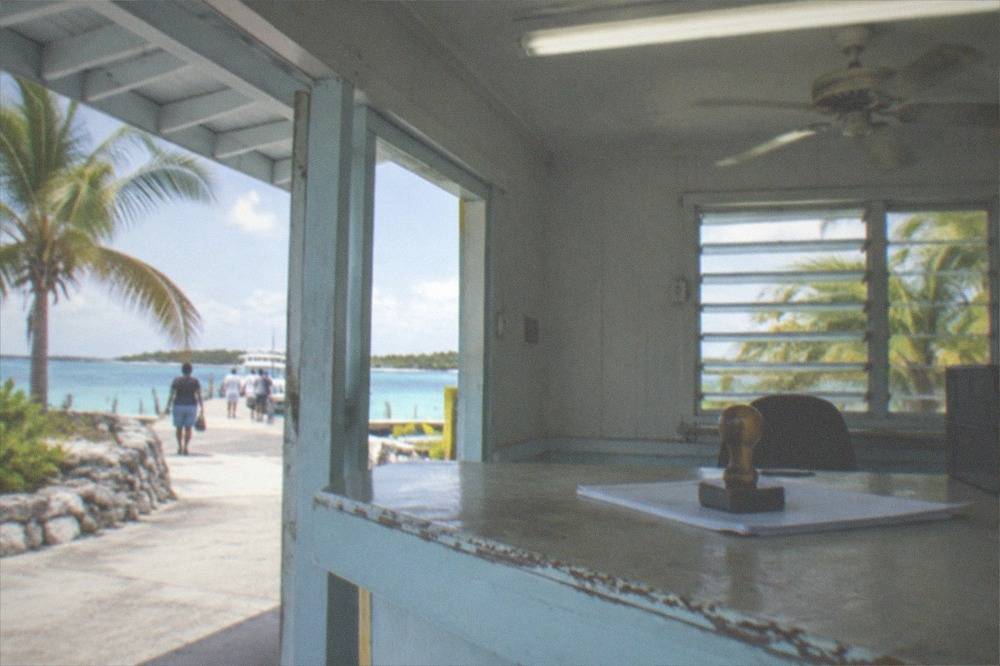 Immigration counter with stamp and forms under bright terminal lighting