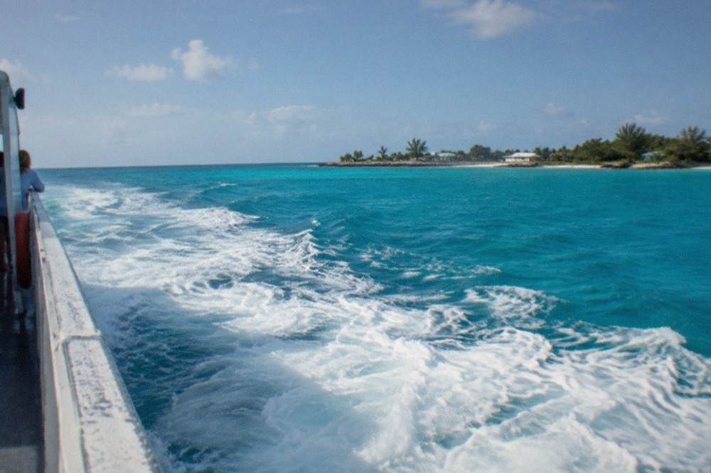 Passenger ferry at sea crossing open turquoise water under a clear sky