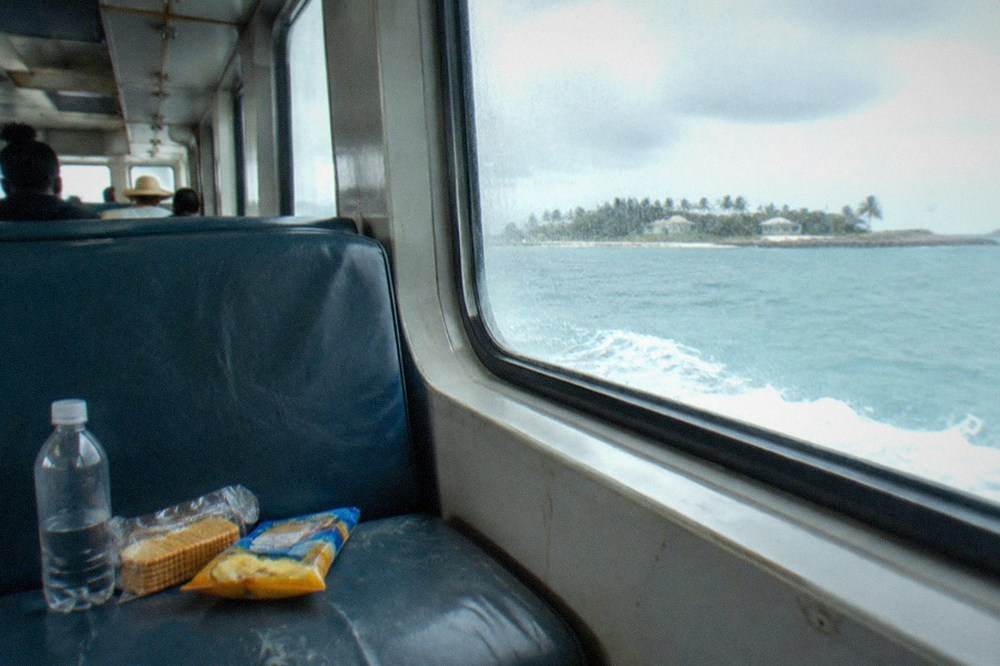 Sealed packaged snacks and a water bottle arranged on a ferry seat