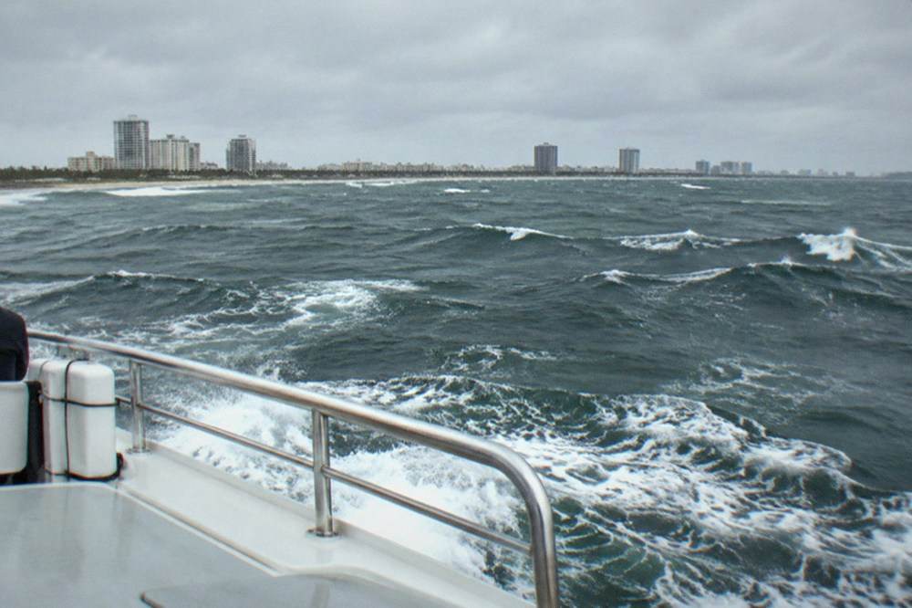 A high-speed ferry crossing open blue water between Florida and the Bahamas