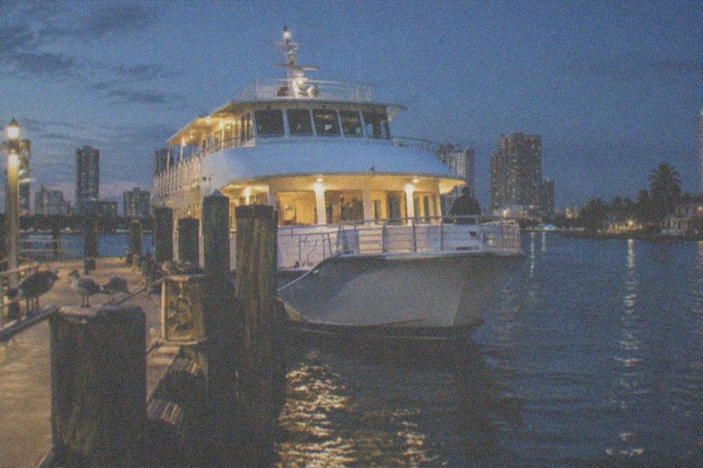 Evening view of a ferry terminal berth with the vessel lit up at dusk