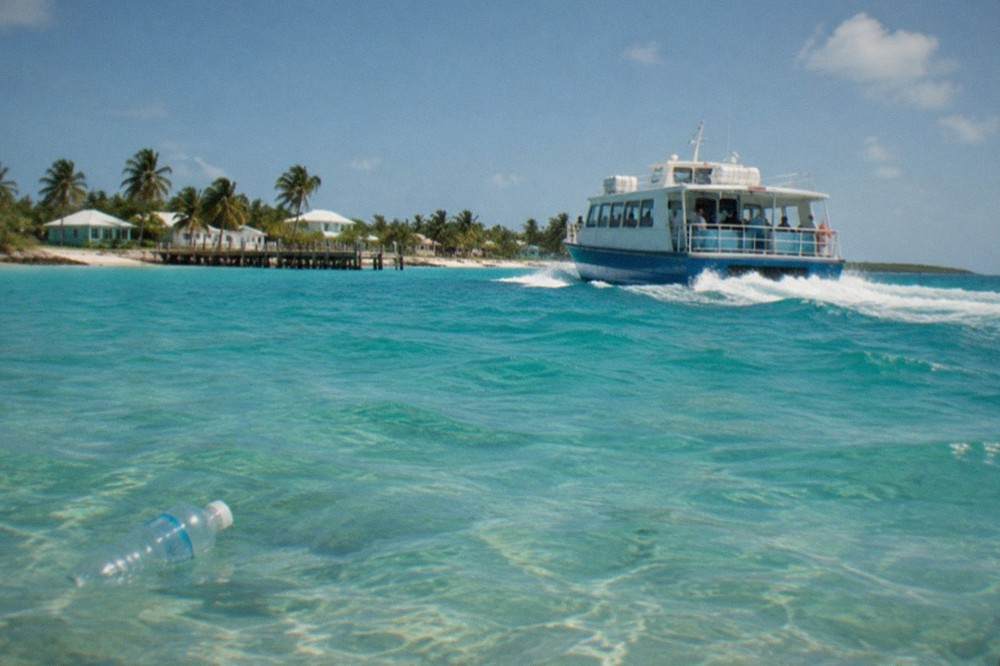 Passenger ferry underway on open turquoise water