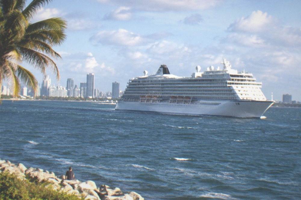 Large cruise ship at sea under a partly cloudy sky