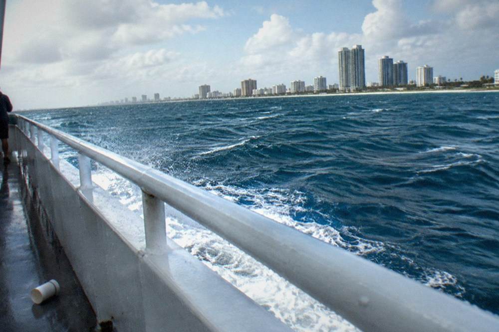 Choppy blue open water with whitecaps under gusty clouds
