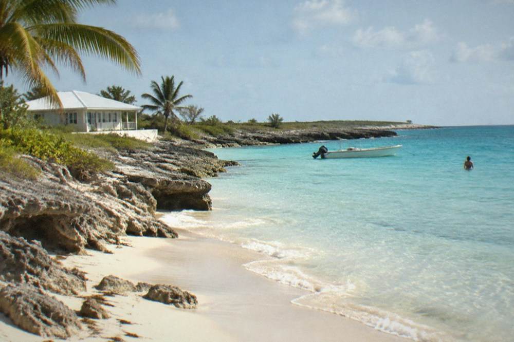 Quiet beach with clear turquoise water along a small island shoreline