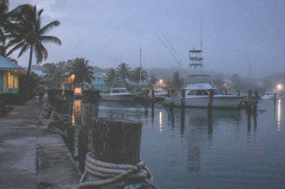Ferry terminal at dusk with calm water and mooring lines