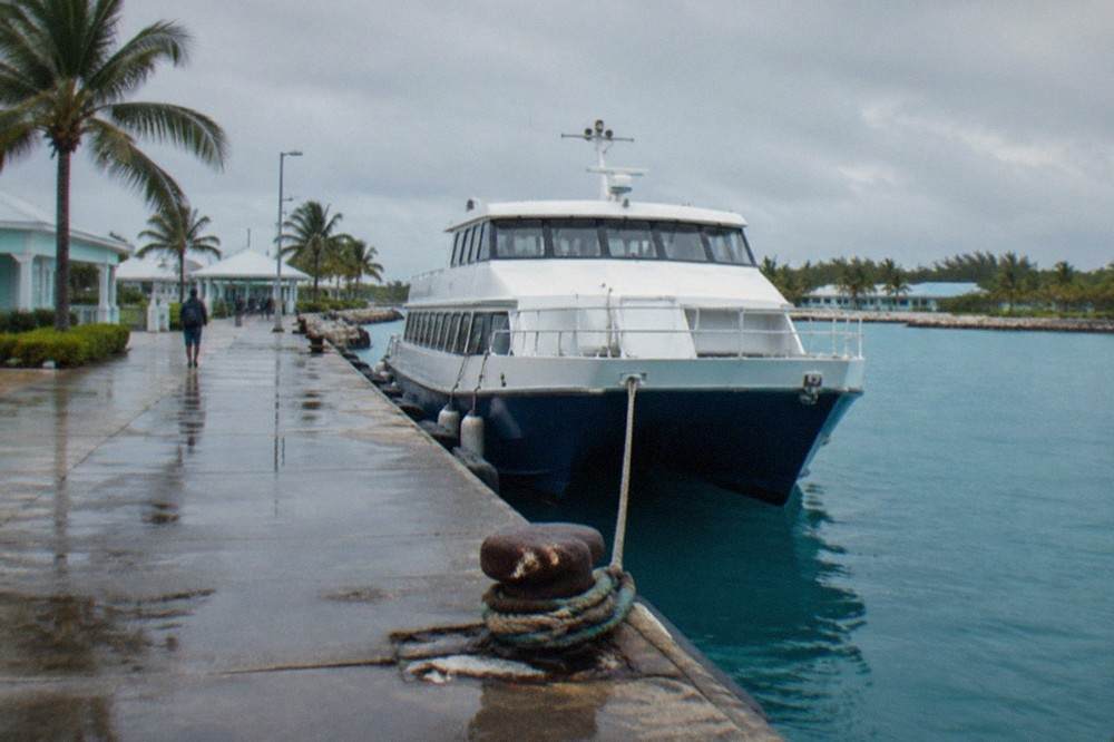 Passenger ferry docked at a Bahamian terminal on calm blue water