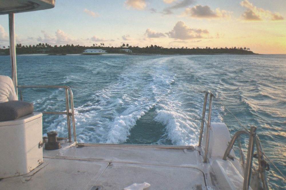 A catamaran ferry underway on open water toward the Bahamas
