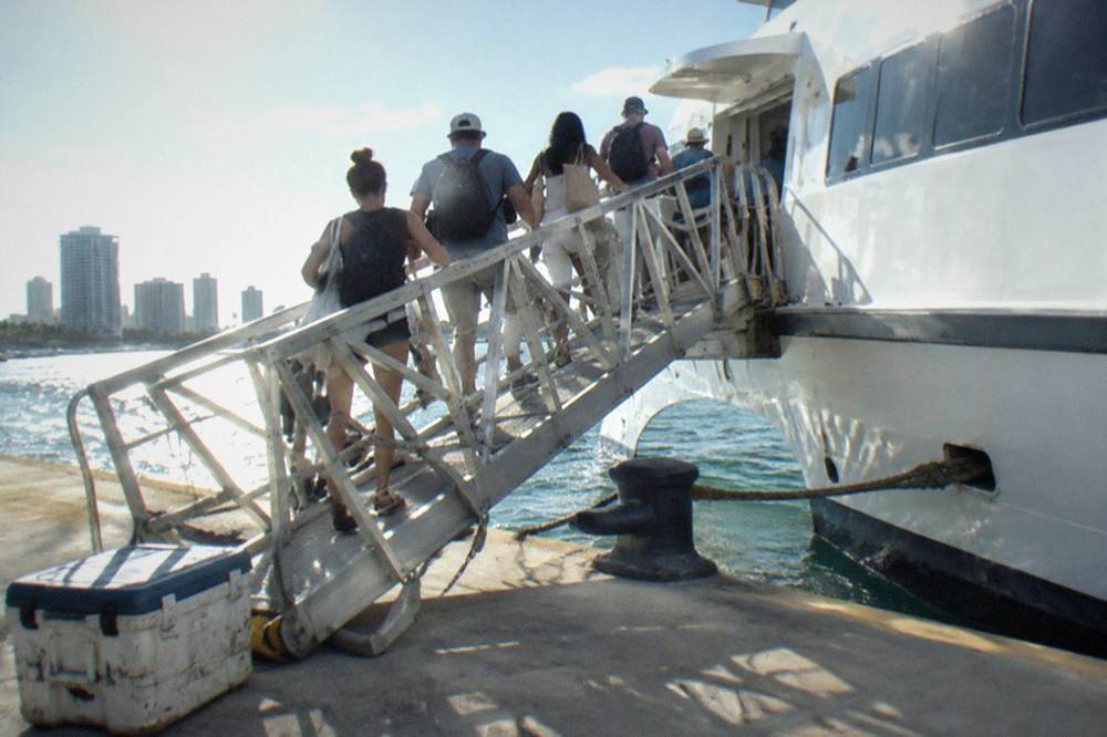 Passengers boarding a high-speed ferry via the gangway at a port terminal