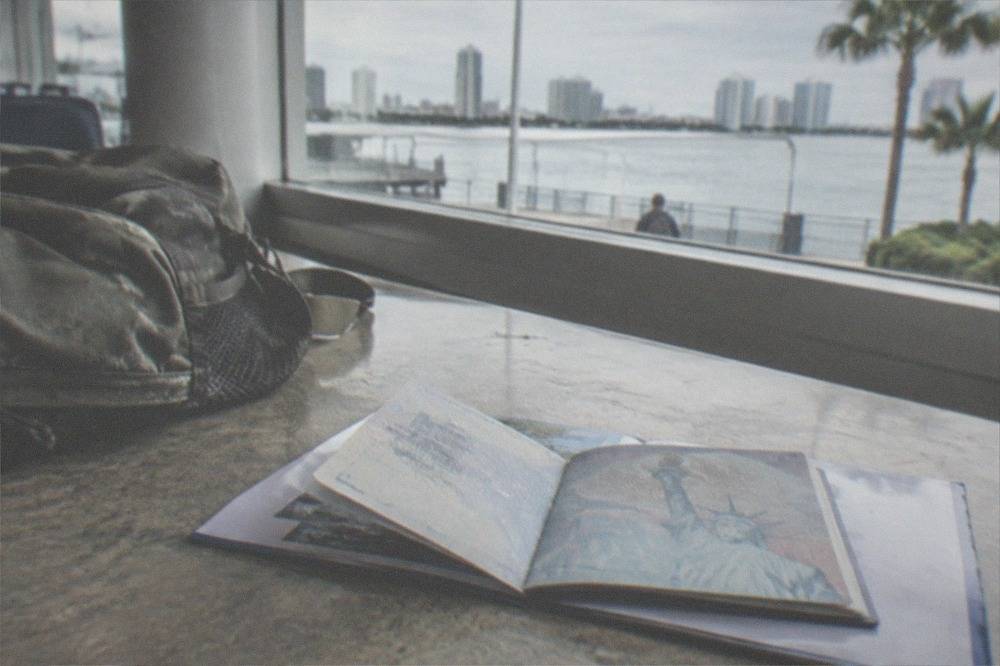 Open passport resting on a boarding pass at a ferry terminal counter