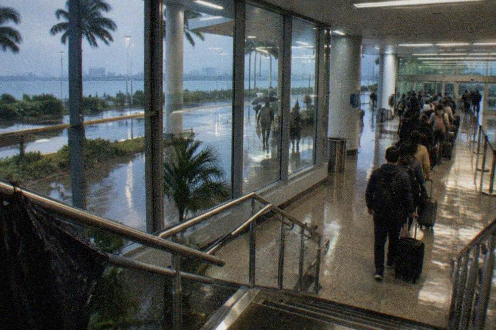 Passengers waiting in a bright ferry terminal departure hall before boarding