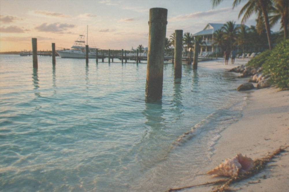 Turquoise shallows and a sandy beach along the Bimini shoreline near the ferry terminal