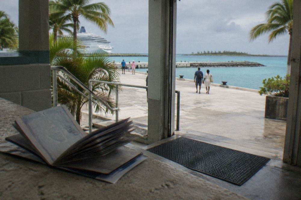 Open passport book resting on a ferry ticket at a terminal counter