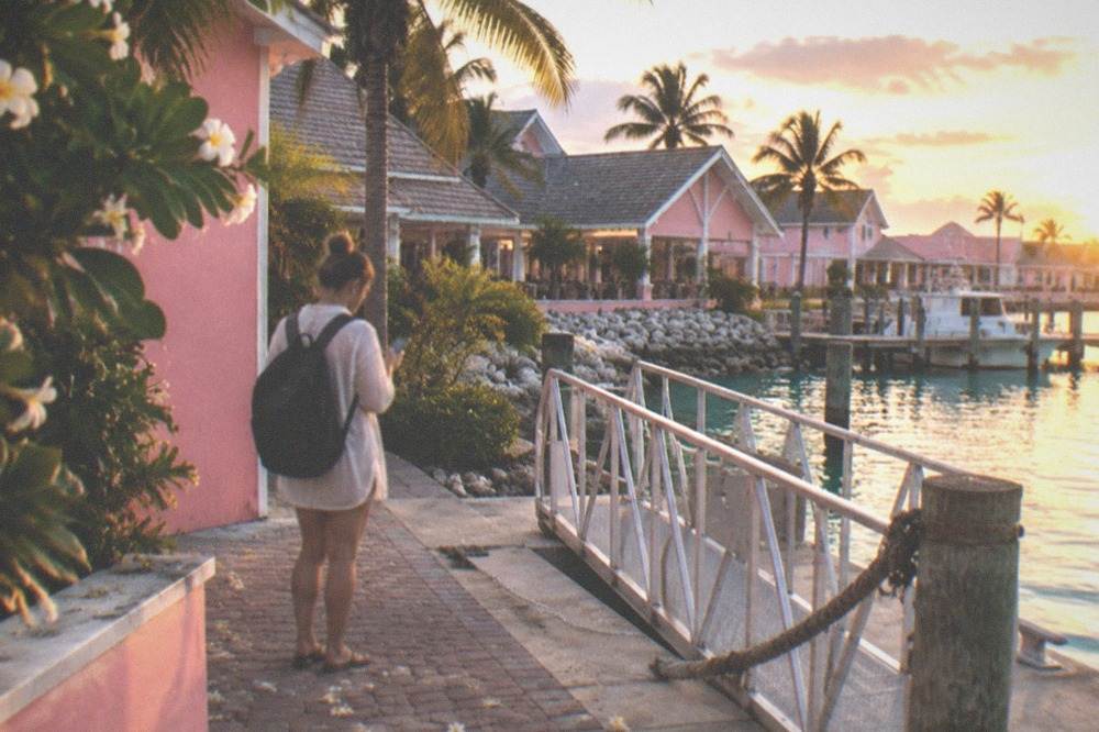 Traveler checking a phone app beside a ferry boarding ramp