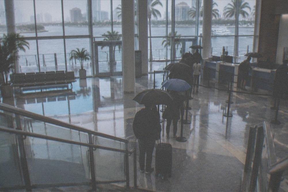 Ferry terminal check-in counters with morning queues of waiting passengers